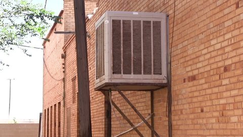 Air conditioner unit on side of industrial building