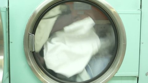A Washing Machine spins rapdly, cleaning clothes