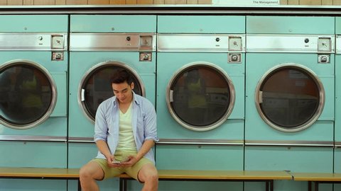 A Young Man and a Young Woman meet in a Launderette whilst doing their laundry