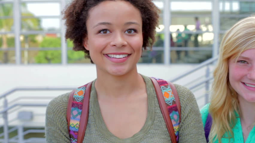 High School Students And Teacher Standing Outside Building