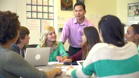 High School Students Collaborating On Project In Classroom