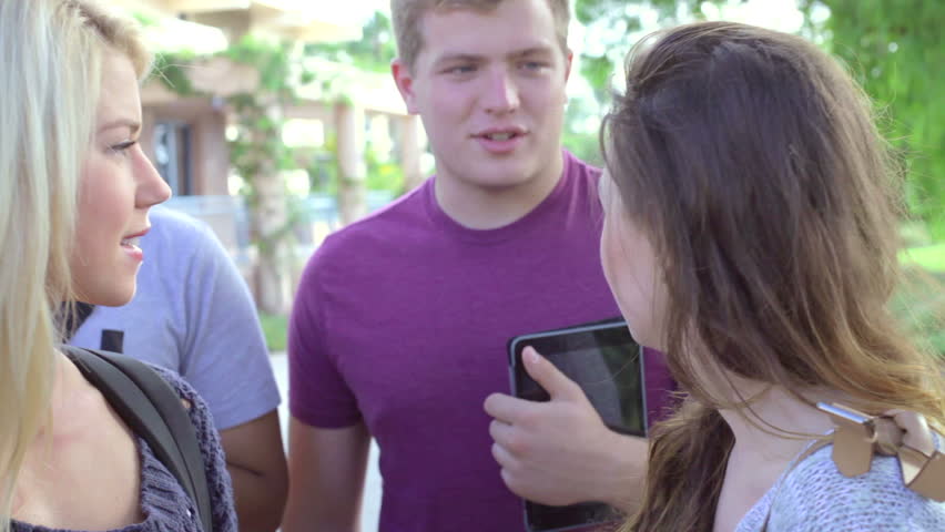 Group Of University Students Talking Outdoors On Campus