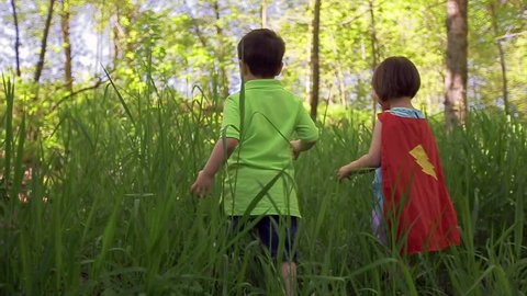 Children Play In Tall Grass, Little Girl Wears Superhero Cape