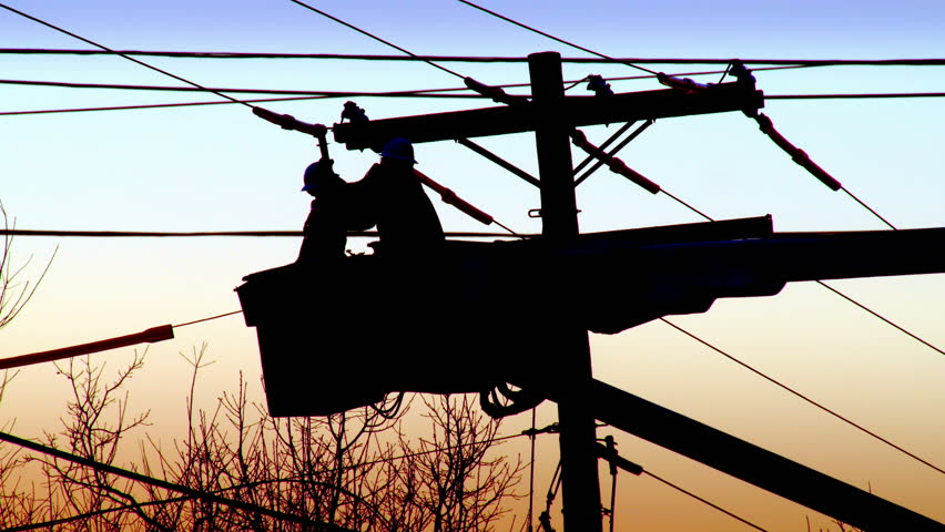 Two utility workers in a cherry picker fix a power line, silhouette Royalty-Free Stock Footage #6452441