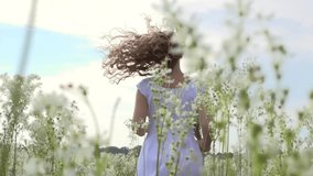 Beauty girl on spring or summer field running and spinning. Beautiful happy joyful young woman outdoors. Freedom concept. Slow motion video footage 1920x1080 full hd. High speed camera shot