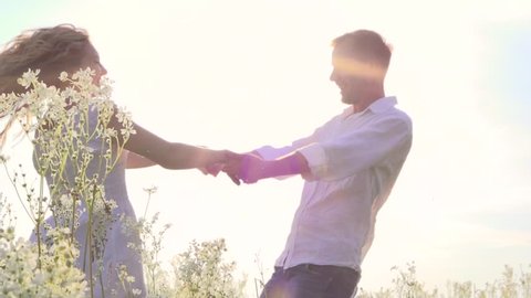 Happy couple having fun outdoor. Young man and woman spinning and laughing. Excited with the freedom of the countryside. Nature. Freedom concept. Slow motion 1920x1080 full hd. High speed camera shot