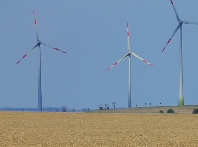 Wind power plants on blue sky background  