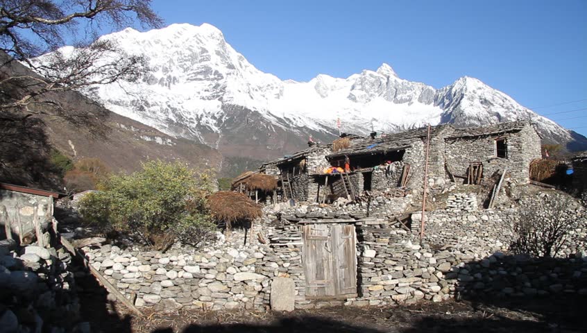 Traditional houses and peak of Manaslu in Samagoon in Nepal
