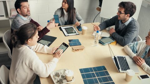Young business people discuss solar panel energy concept