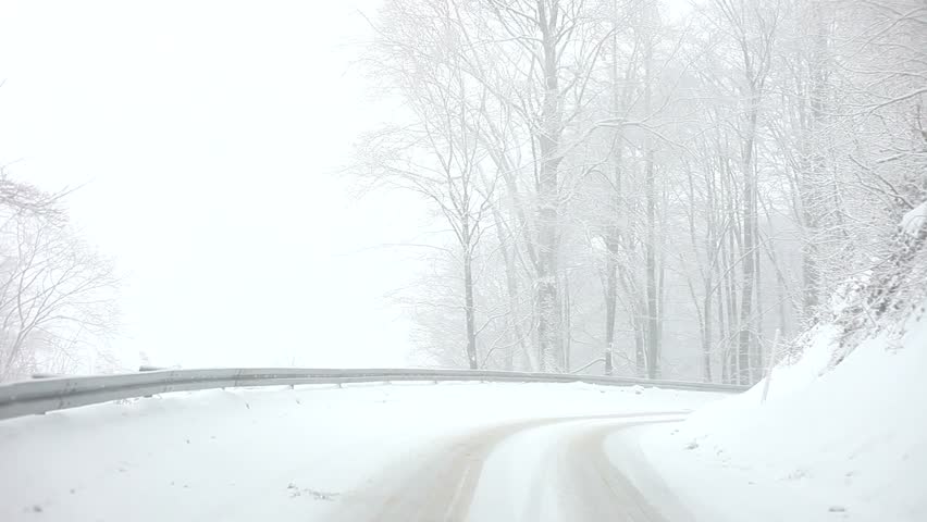 Car driving on Snow Blizzard on winter snow forest road