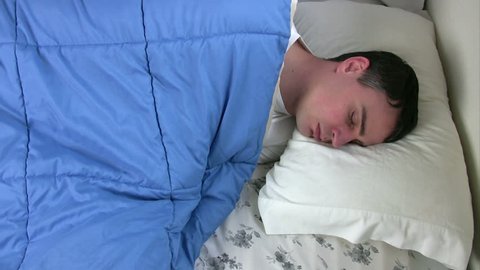 Man trying to sleep but can not get comfortable