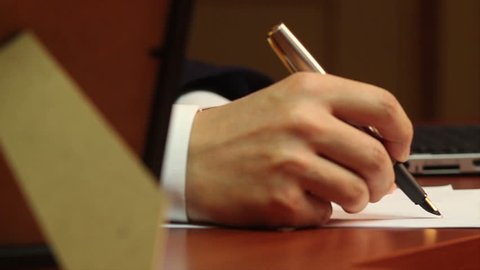 Male worker making notes, handwriting, businessman at work