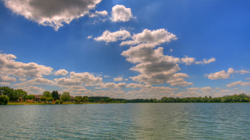 Blue sky over lake, HD time lapse clip, high dynamic range imaging