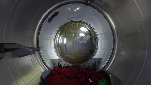 Brightly Colored Clothes Spin Through Dryer at Full Speed