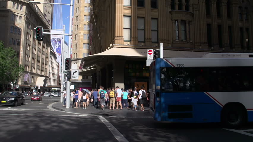 Tilt pan from the street corner to the Sydney Tower