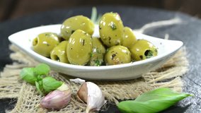 Small bowl with pickled Green Olives (loopable video)