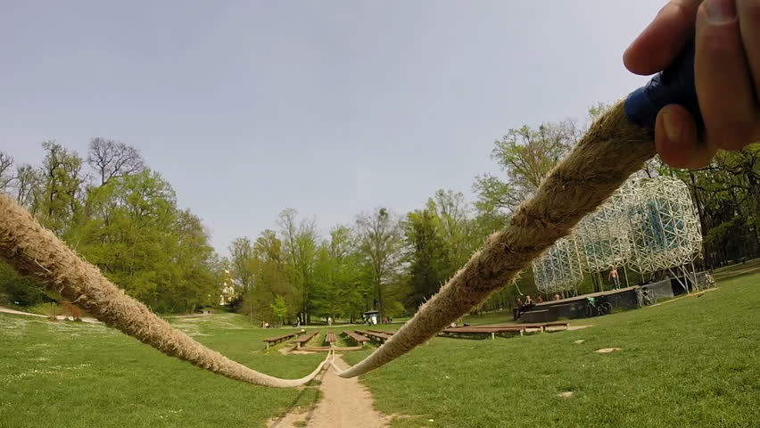 Muscular man doing waves with undulation ropes