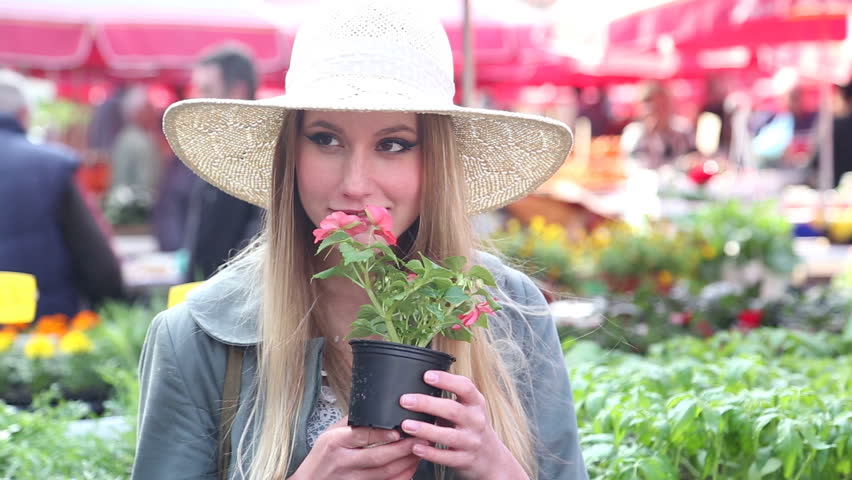 Close up of a girl holding and smelling flowers
