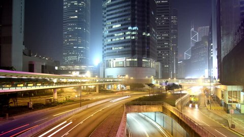 Cityscape timelapse at night. Hong Kong. Busy traffic across the main road at rush hour.