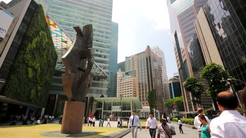 SINGAPORE - CIRCA FEB 2014: People at Raffles Place. Several key buildings are located in Raffles Place, including UOB Plaza, One Raffles Place, Republic Plaza, One Raffles Quay and OCBC Centre. 
