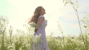 Happy young woman having fun outdoor. Beauty girl spinning and laughing. Excited with the freedom of the countryside. Nature. Freedom. Slow motion video footage 1080p full HD. High speed camera shot