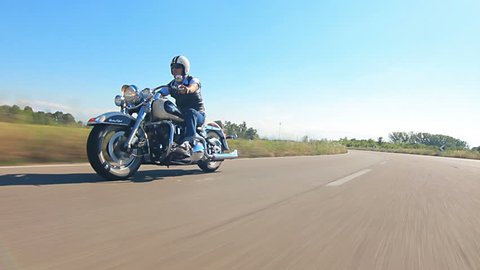 man riding his motorcycle on a highway follofw shot car point of view
