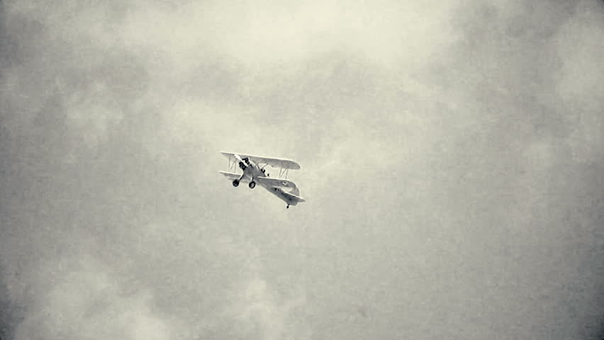 Old biplane in flight grainy black and white footage