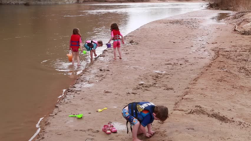 Children playing on a beach near the San Juan River in Southern Utah