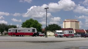 Video of American Red Cross emergency response vehicles in San Antonio, Texas. Red and white trailer RV, communication center and ambulance ready for hurricane. 