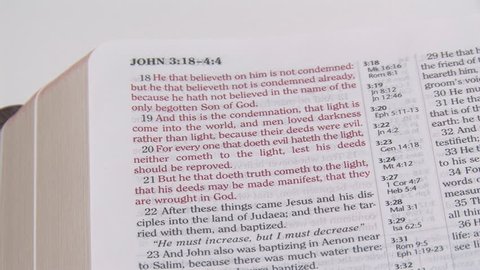 Using a yellow highlighter to mark Bible verses in the KJV Bible. First the bad news (John 3:19) and then the good news (Romans 8:1).