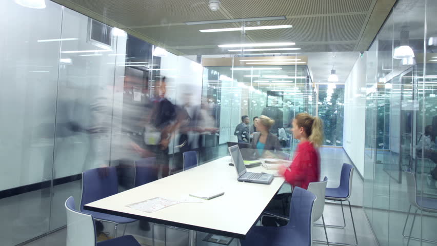 Time lapse of young attractive business group in a meeting in modern city office