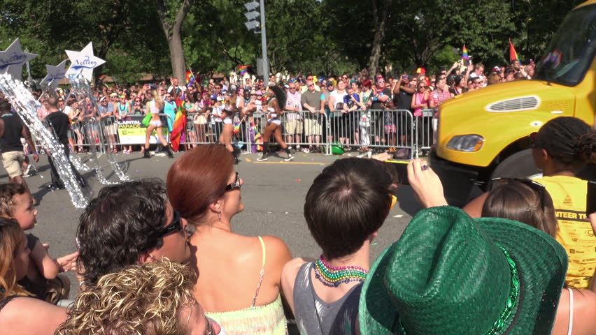 WASHINGTON, DC - JUNE7, 2014: Washington Capital Pride Parade, float from gay sports bar with buff shirtless guys passes excited throngs of viewers at Dupont Circle.  Formerly called Gay Pride Parade.