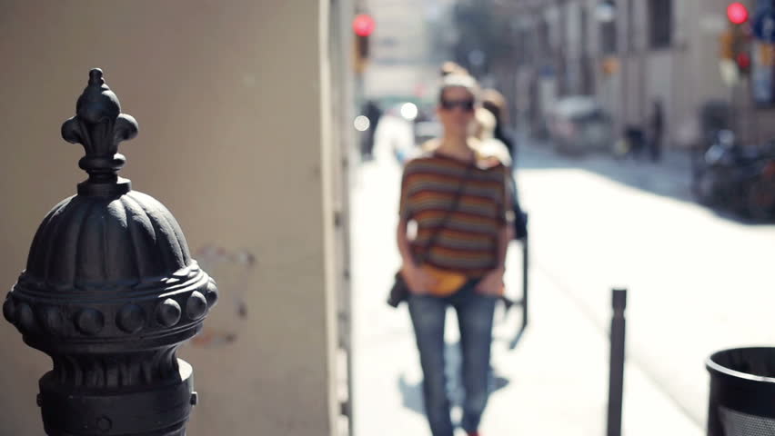 Portrait of young happy woman in the city
