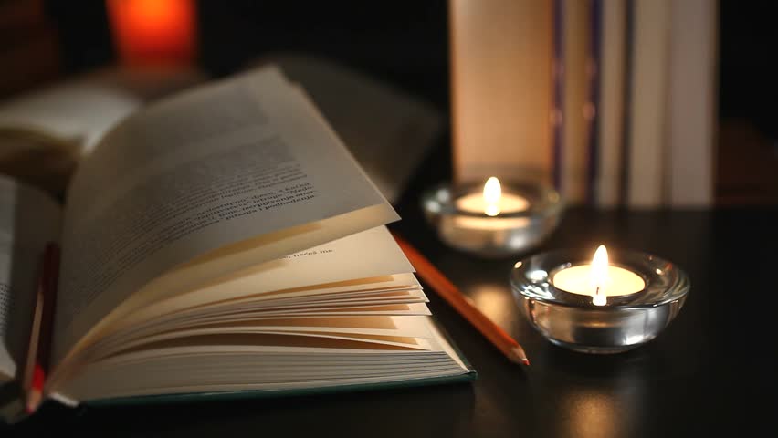 Books and candles camera moving left