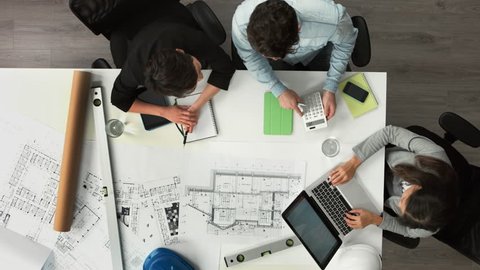 Architect plans arial view business meeting showing teamwork young diverse startup