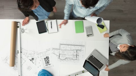 Architect plans arial view business meeting showing teamwork young diverse startup