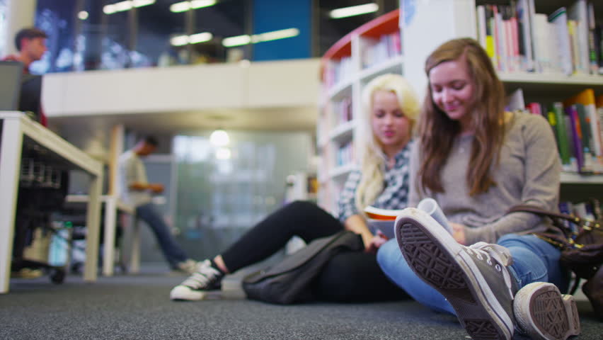 Diverse student group working and studying together in college library