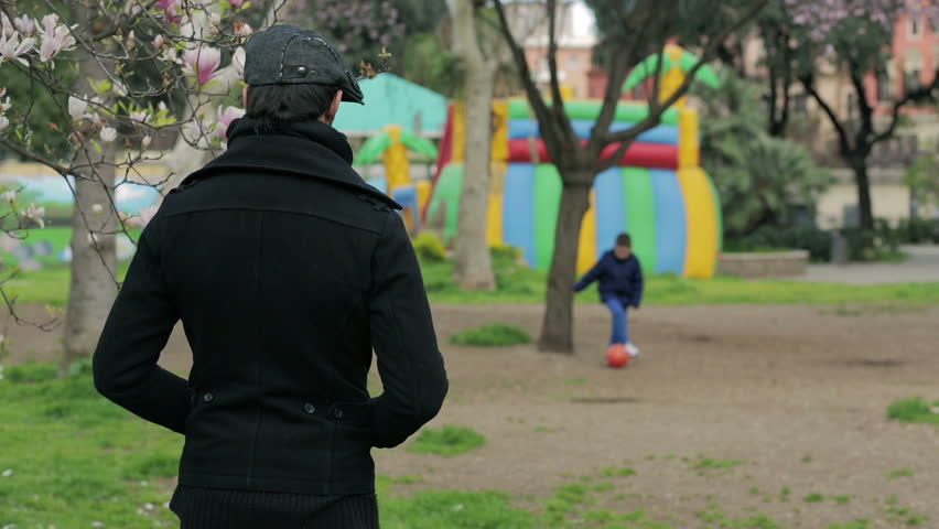 a child playing in the garden runs to dad embracing him with love: father, hug,