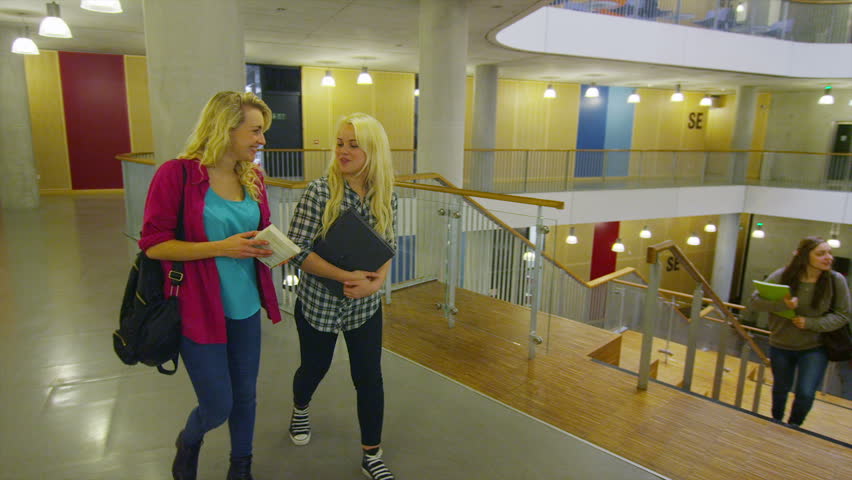 Diverse student group in a large modern university building.