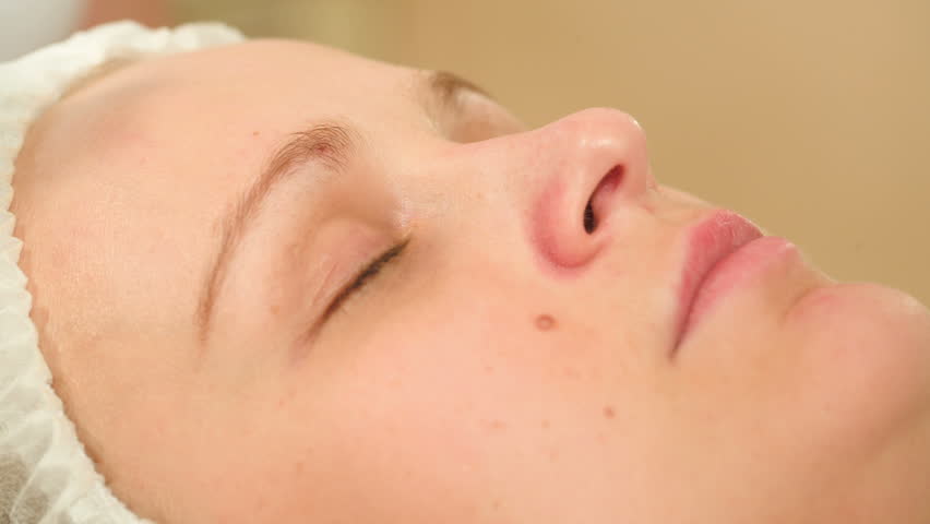 Close-up shot of a woman under ultrasonic cleaning of a nose