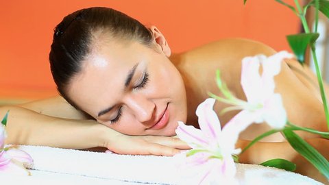 woman in spa looks at camera and smiles  - 1080p