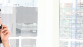 Brunette business woman talking on headset in a call center - Powered by Shutterstock - Get 15% off with code: PIKWIZARD15