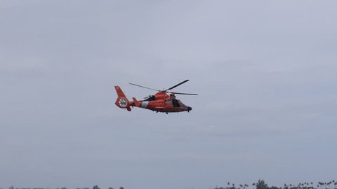 Coast Guard rescue helicopter flying away.