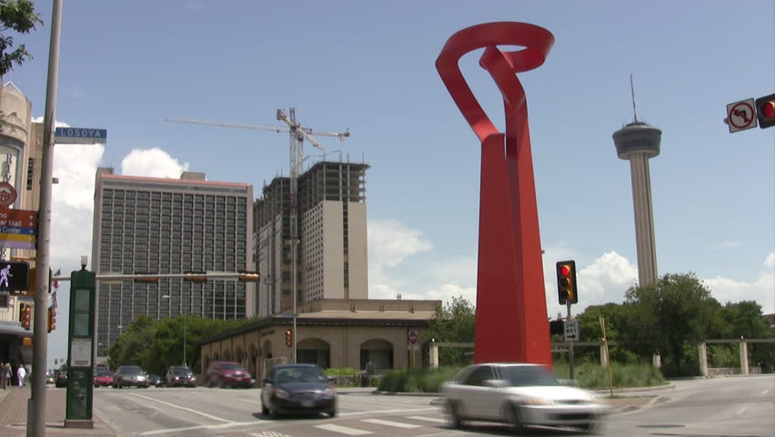 Video of downtown San Antonio Texas with the tower of the Americas and orange gift from Mexico with traffic speeding by in fast time lapse. 