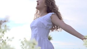 Happy young woman having fun outdoor. Beauty girl spinning and laughing. Excited with the freedom of the countryside. Nature. Freedom. Slow motion video footage 1080p full HD. High speed camera