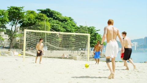 Friends practice soccer skills on a beach