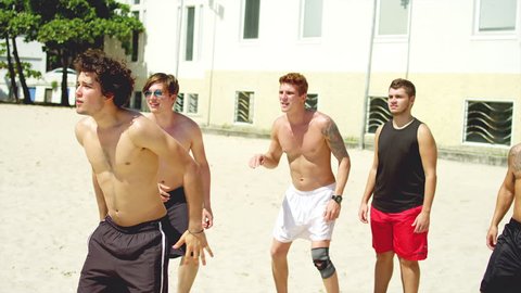 Friends compete to score a header at the beach