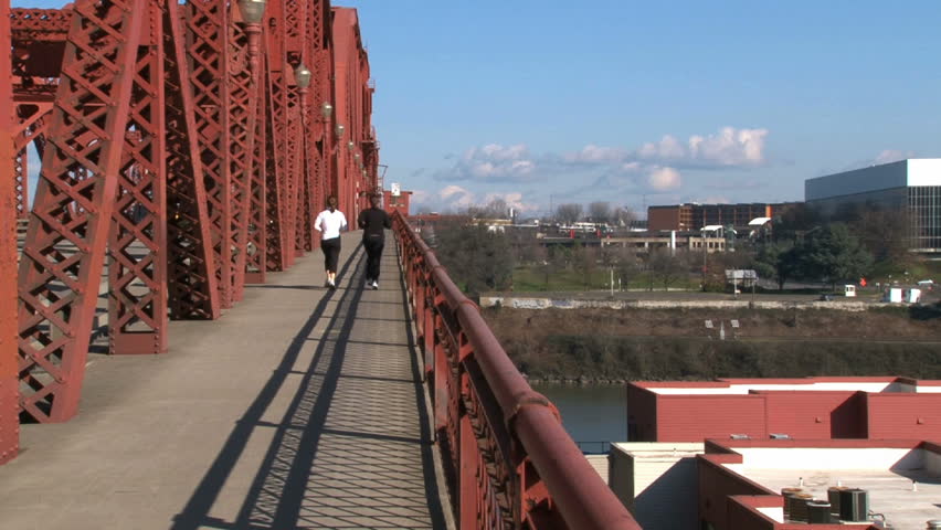 Two women exercising by running across the Broadway Bridge in Portland, Oregon. 