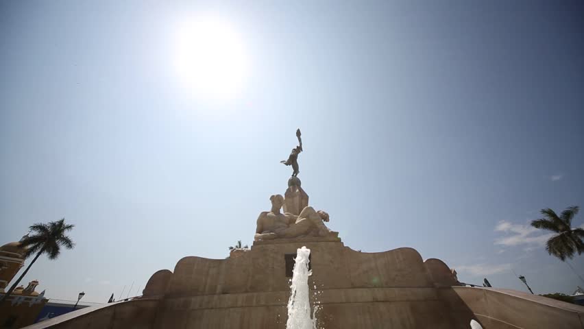 video footage of the main square (Plaza de armas) with old colonial buildings and the freedom monument in the city of Trujillo, Peru.