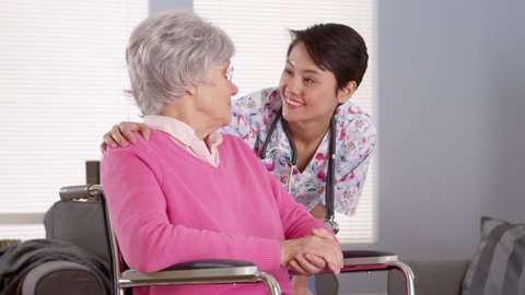 Chinese nurse talking with Senior patient